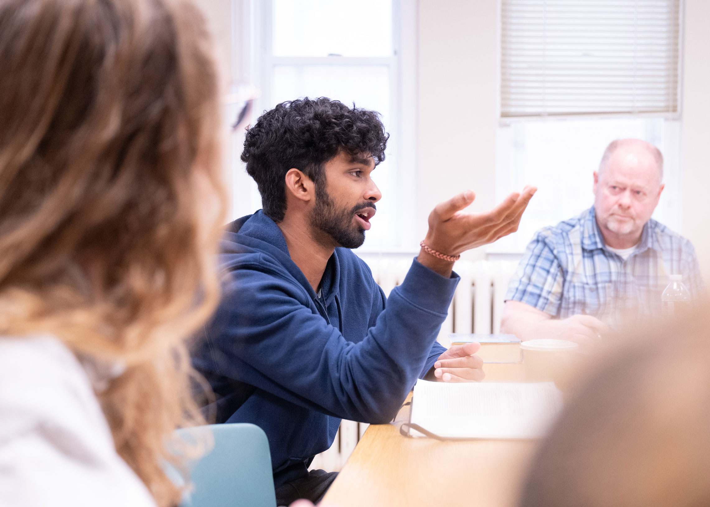 Student discussing in a classroom.